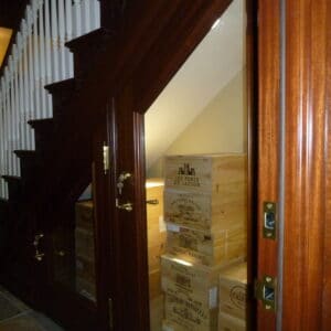 Wooden staircase in a house with a wine cellar